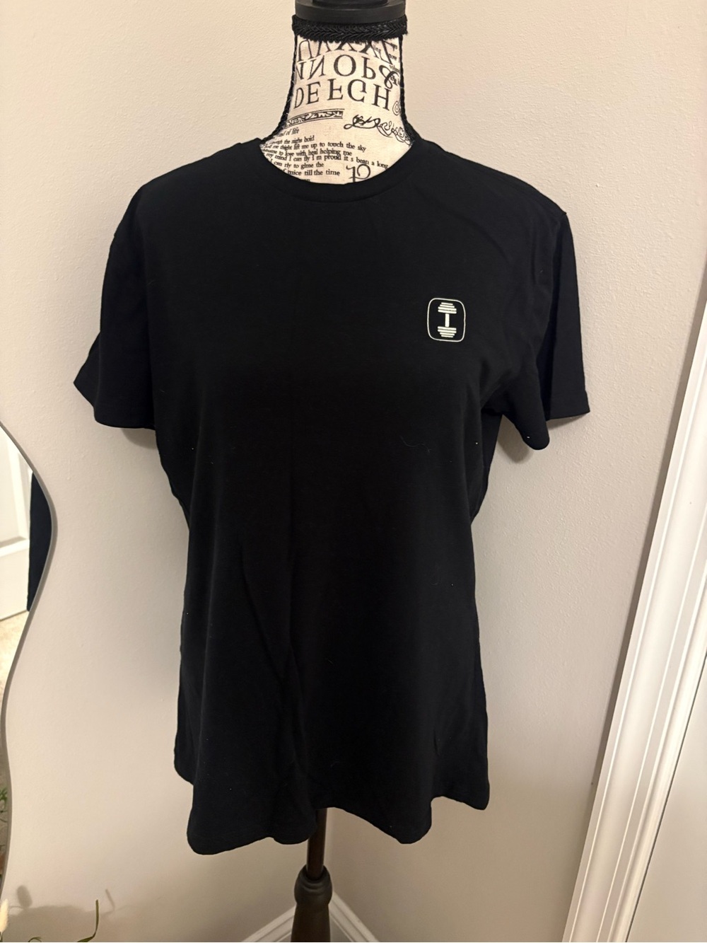 Black Women's Crewneck Tee with Subtle Chest Icon